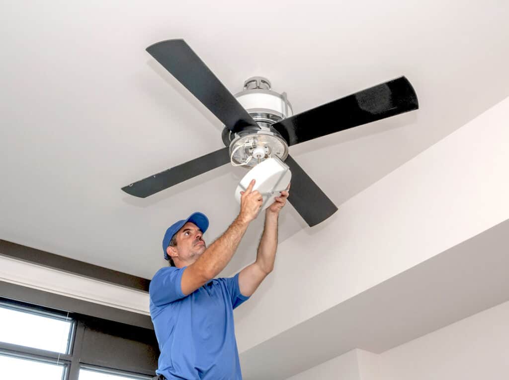 A technician doing a fan installation | electrical services